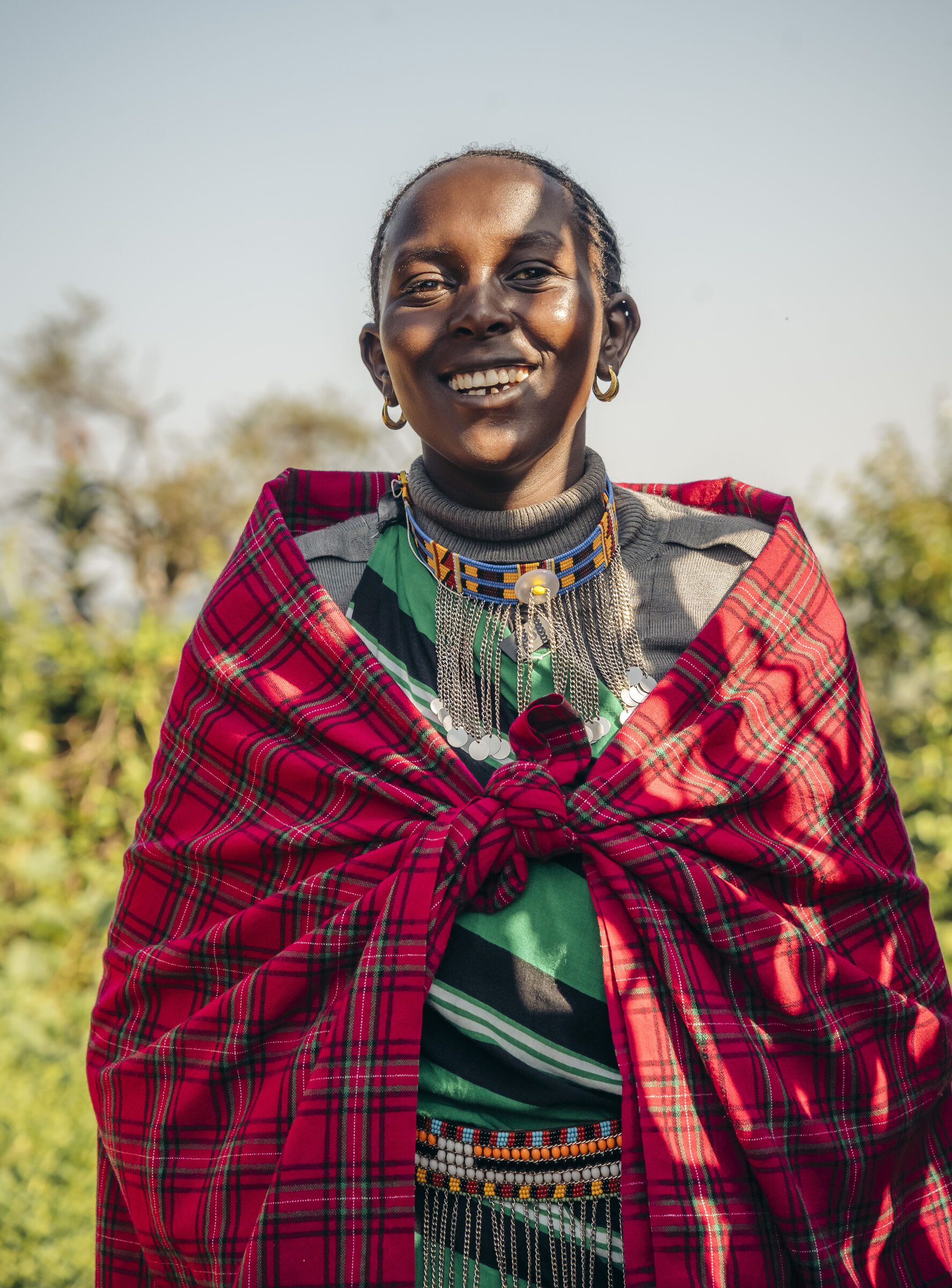 Smiling Maasai woman wrapped in a red shuka