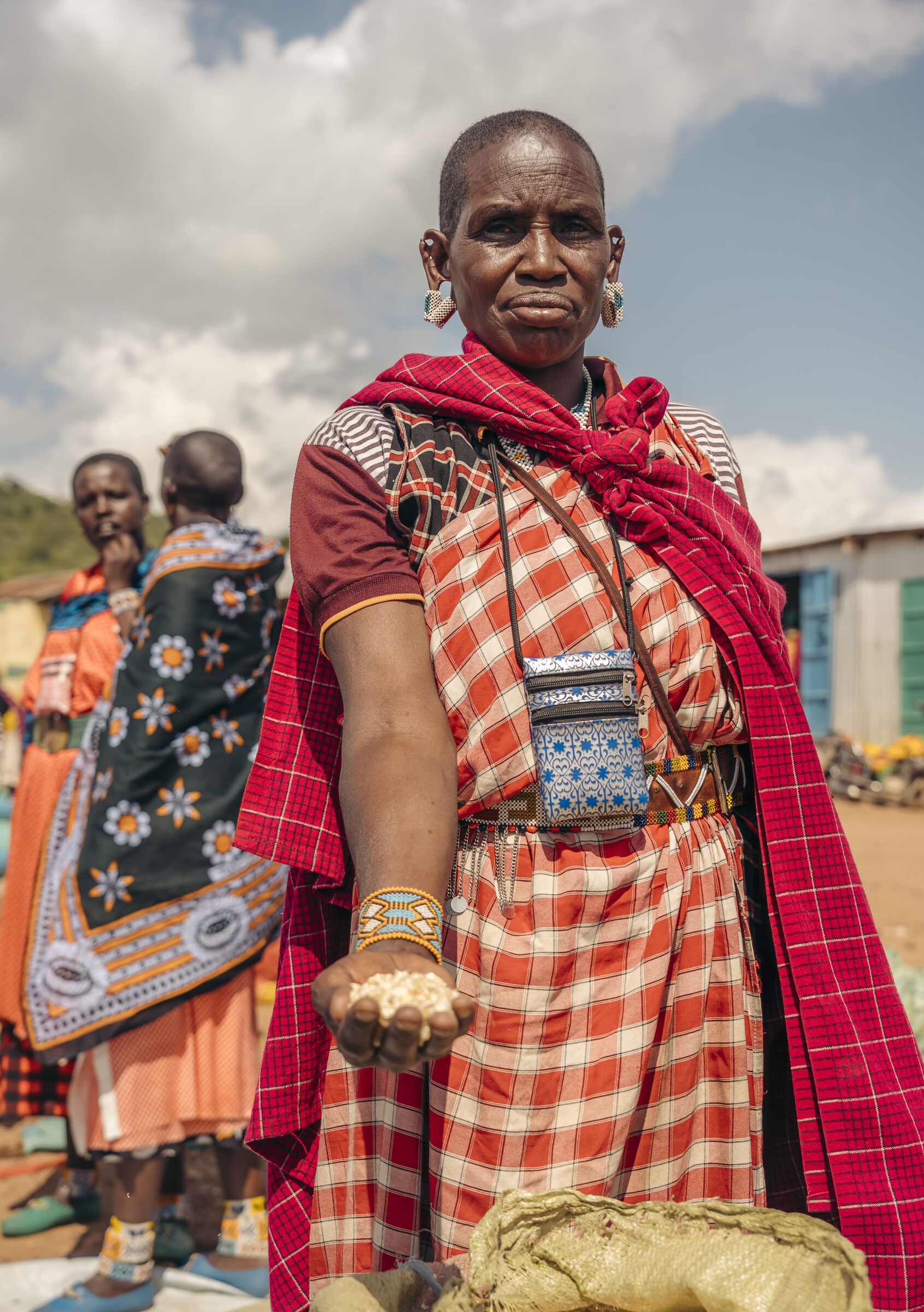 Maasai elder standing at a market