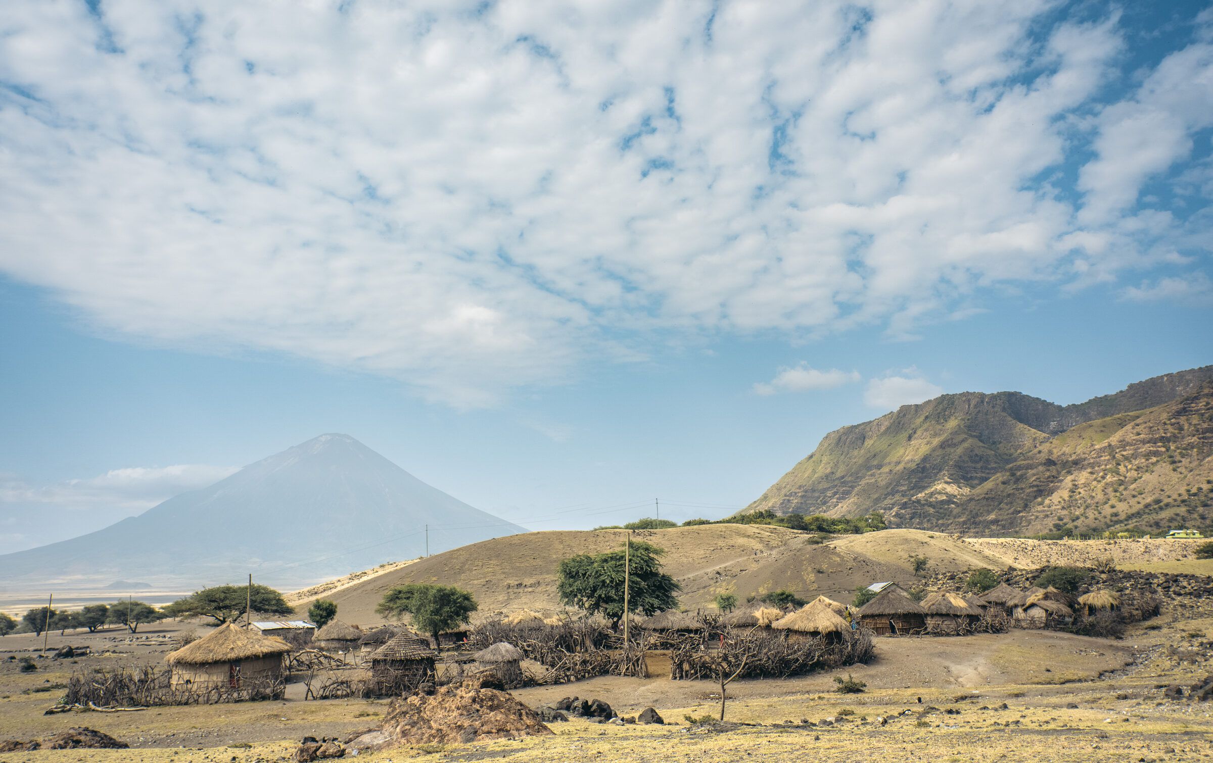 Plains and homesteads beneath a volcano